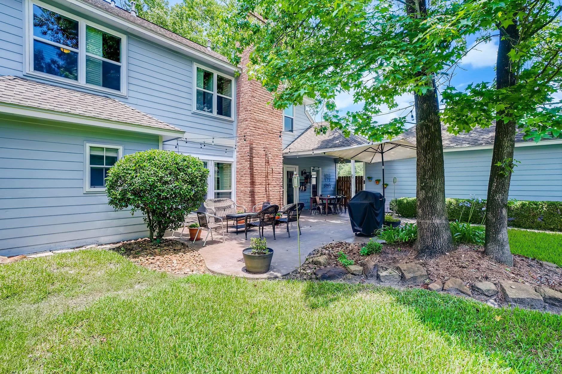 A shaded Owings backyard with mature trees and foundation beds