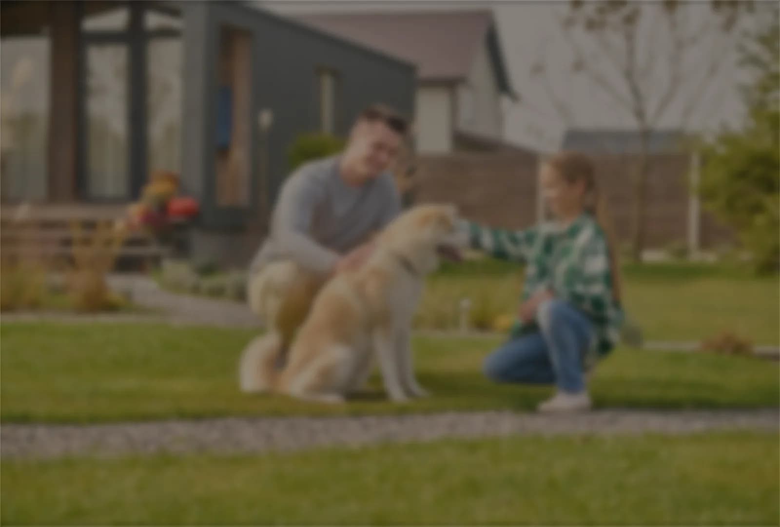 A homeowner and their dog in front of their house