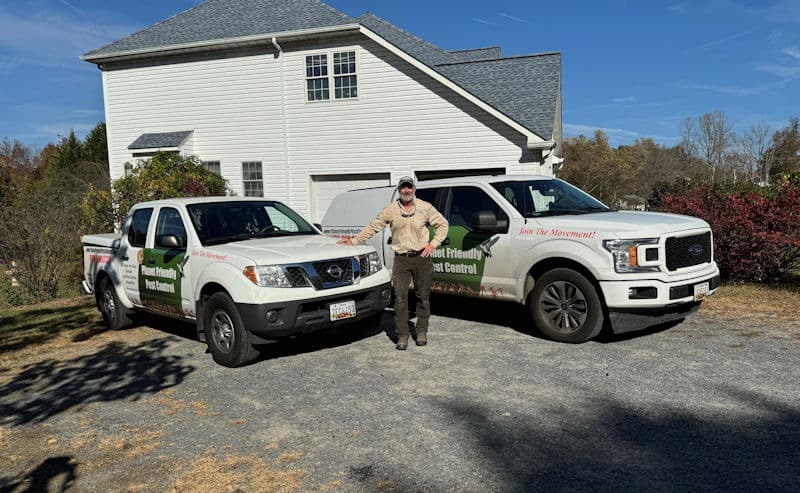 Gene Wright, owner of Planet Friendly Pest Control, with the company trucks