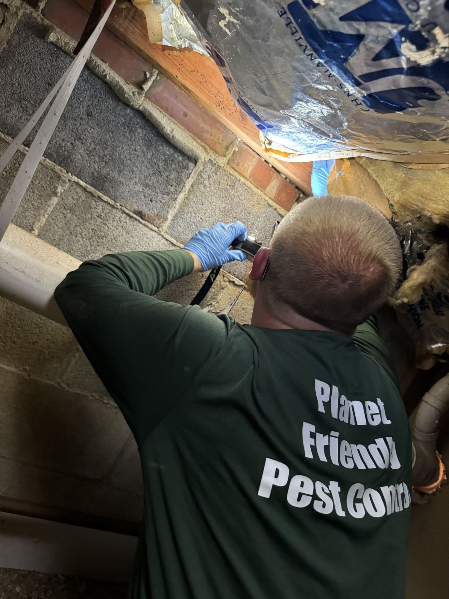 A Planet Friendly Pest Control technician performing an exterior treatment near Newburg MD