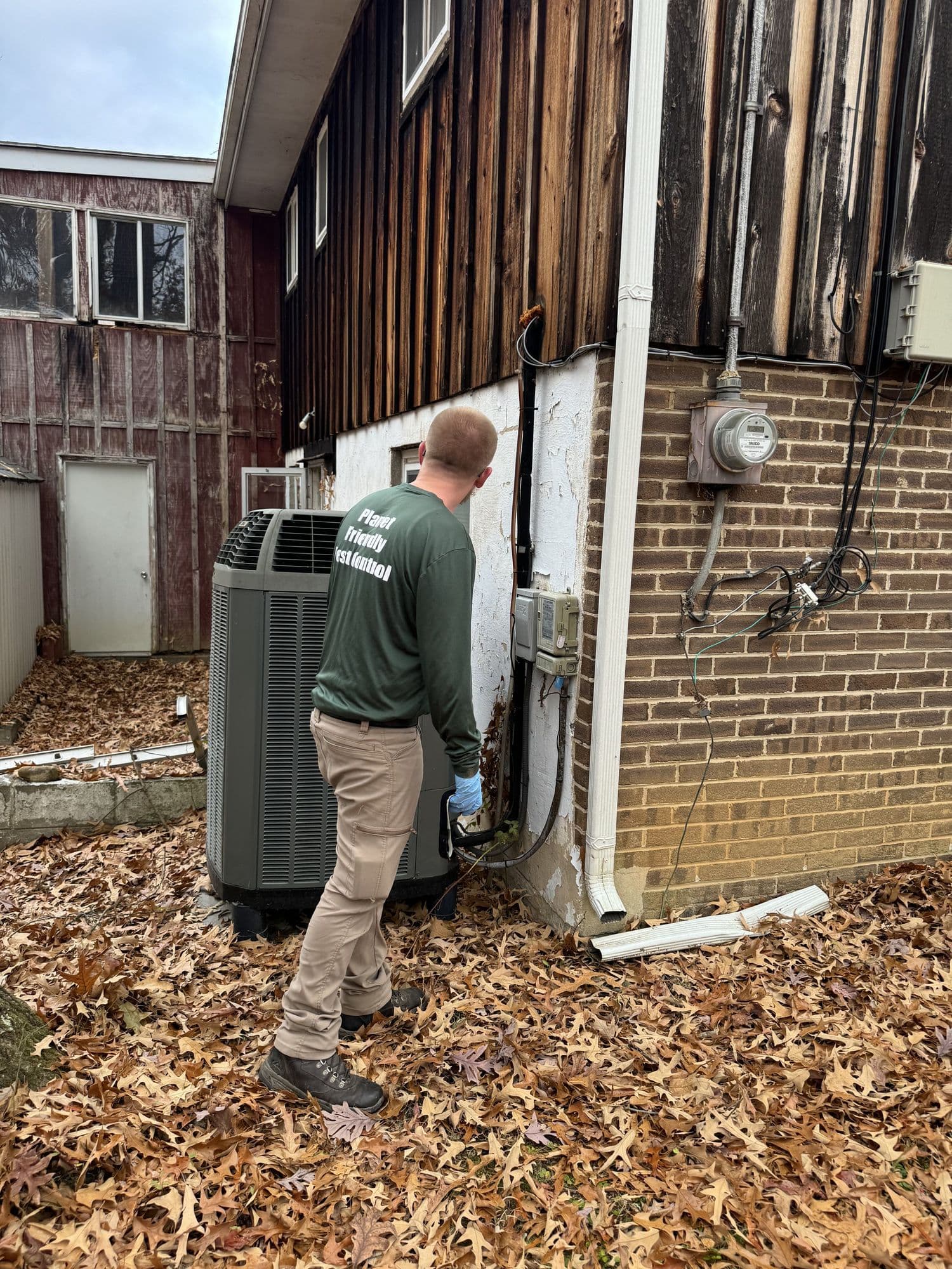 A Planet Friendly Pest Control technician performing an exterior treatment near Belle Haven VA